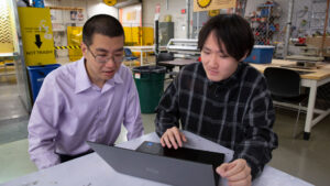 Zhengbin Chen (right), a senior engineering major focusing on the robotics concentration, works on an additive manufacturing model with his faculty mentor, Andi Wang, an assistant professor of manufacturing engineering.