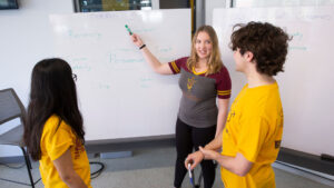 Daniella Pautz (center), a biomedical engineering graduate student, works with FURI students Maxwell Johnson (right) and Ruhi Dharan (left). Pautz’s research explores how methods of persuasion used by engineering professors can affect students’ performance and well-being.