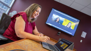 Software engineering student Crislana Rafael (pictured at left on the monitor) meets with mentors Maria Dixon (pictured at right on the monitor) and Deana Delp (left).